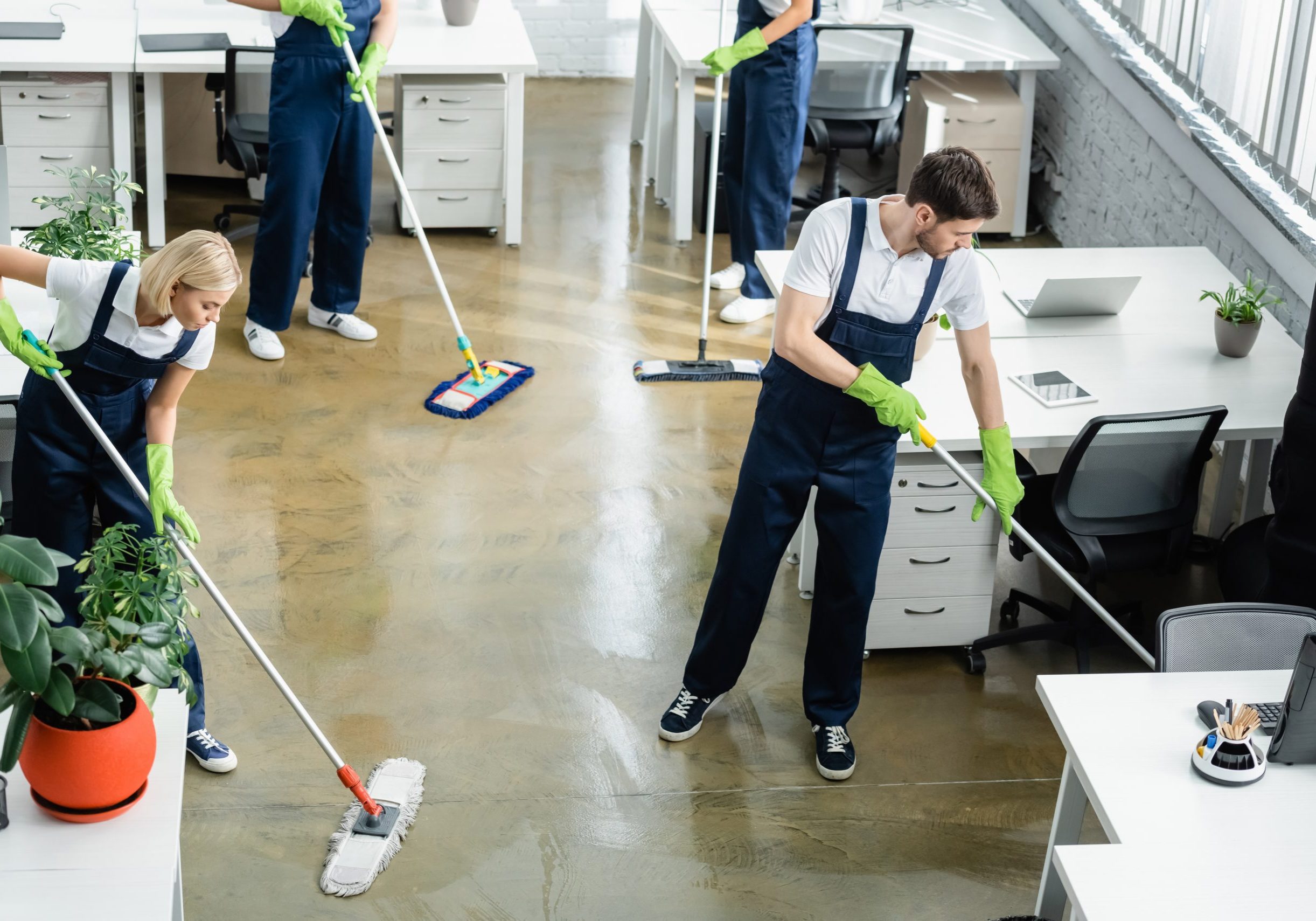 A team of professionals cleaning an office space, showcasing commercial cleaning practices in action.